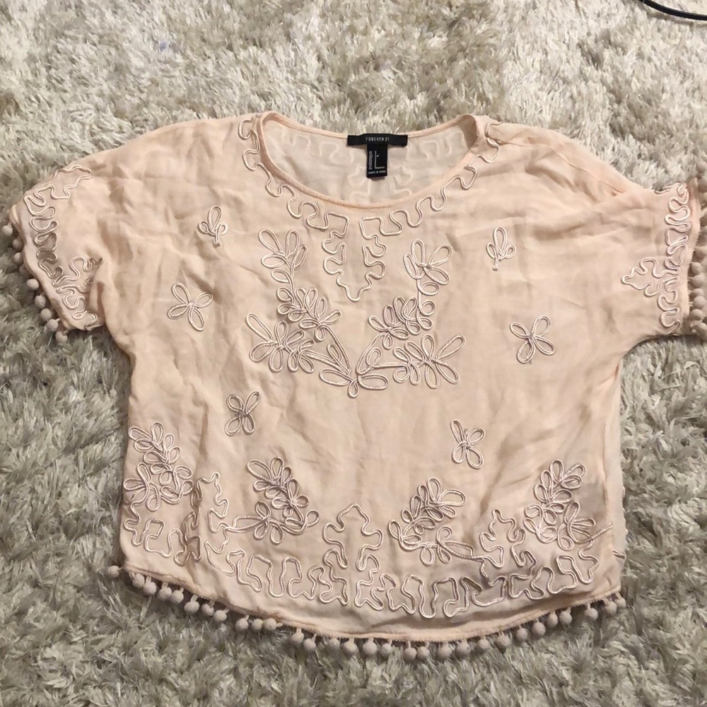 Pastel pink shirt with pompoms